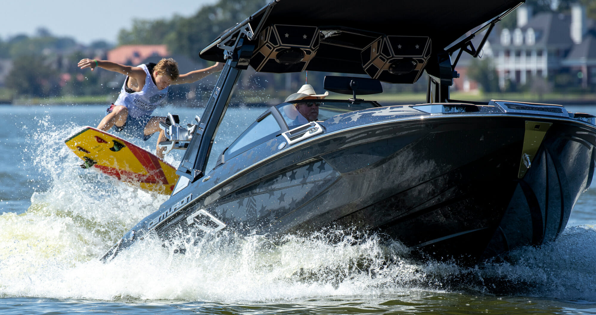 Wake surf competitor behind a Centurion boat