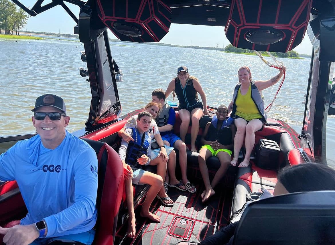 A group of people sitting in the back of a boat.