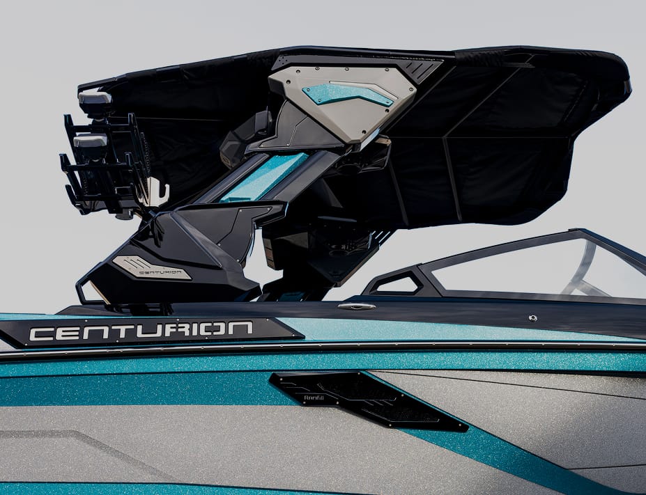 Close-up of a blue and gray Centurion boat featuring a folded black Bimini top, visible branding on the side, and sleek Centurion Towers overhead.