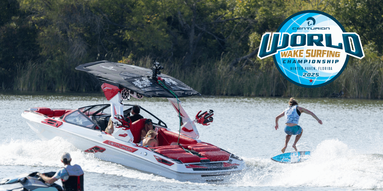 A person wake surfing behind a white and red speedboat on a lake with spectators nearby; World Wake Surfing Championship 2025 logo is displayed.