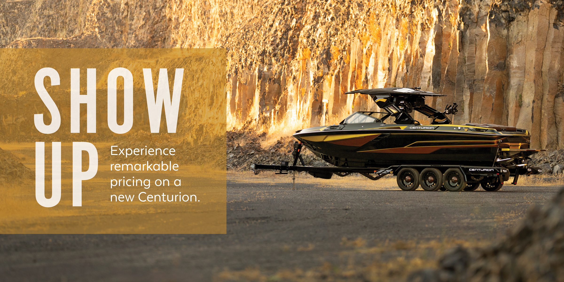 A black and yellow Centurion boat on a trailer is parked in front of a rocky cliff; promotional text appears on the left.